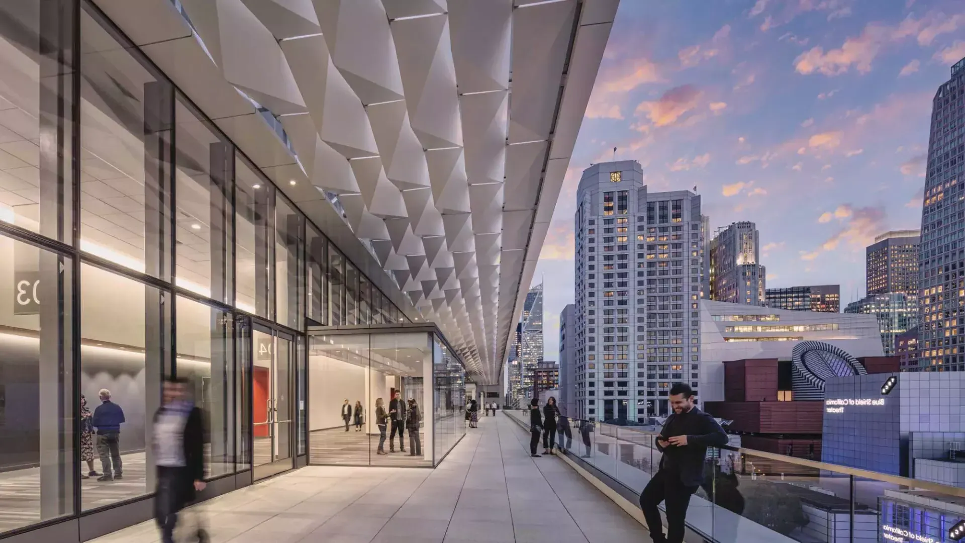 Meeting attendees stand and stroll on a balcony at Moscone Center South in San Francisco.